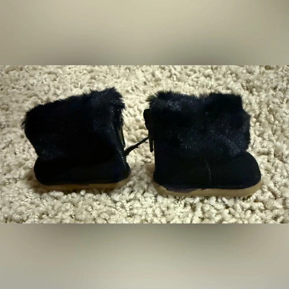 Labubu accessories: black shearling boot with zipper, and black glasses